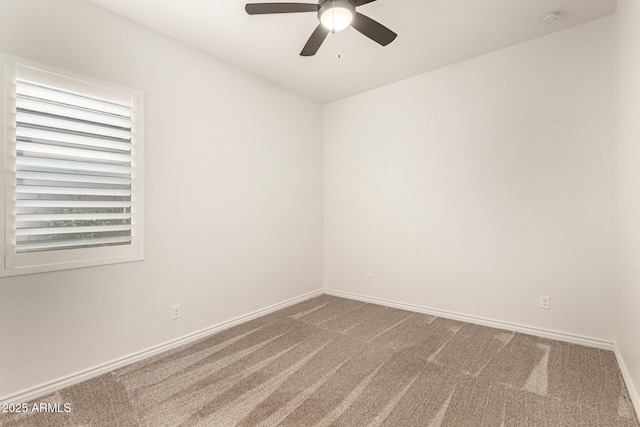 unfurnished room featuring dark carpet, ceiling fan, a smoke detector, and baseboards