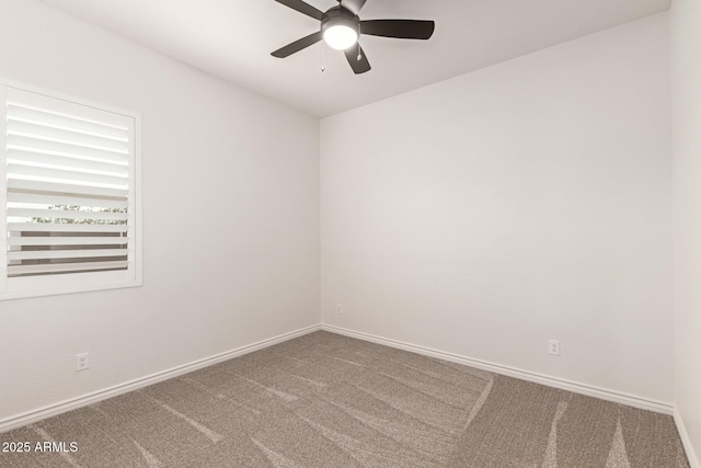 unfurnished room featuring carpet flooring, a ceiling fan, and baseboards