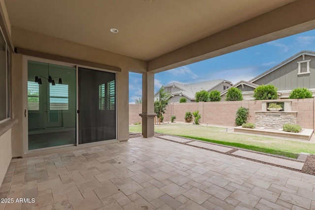 view of patio featuring fence