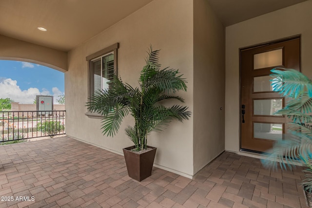 entrance to property featuring stucco siding