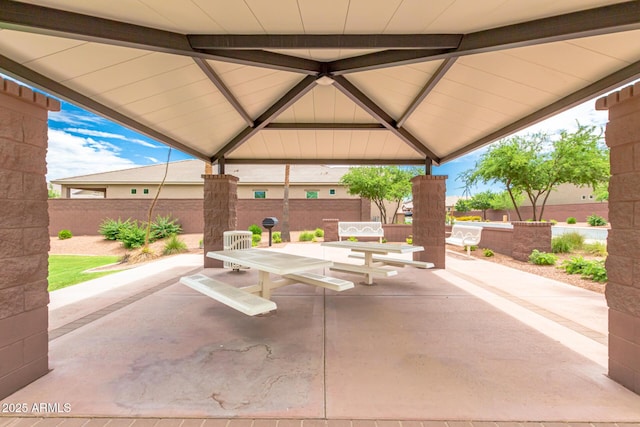 view of patio / terrace featuring a gazebo, fence, and outdoor dining area