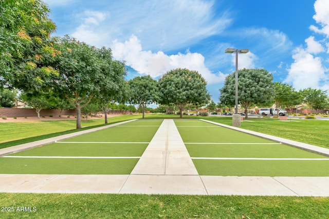 view of home's community featuring a bocce ball area and a yard