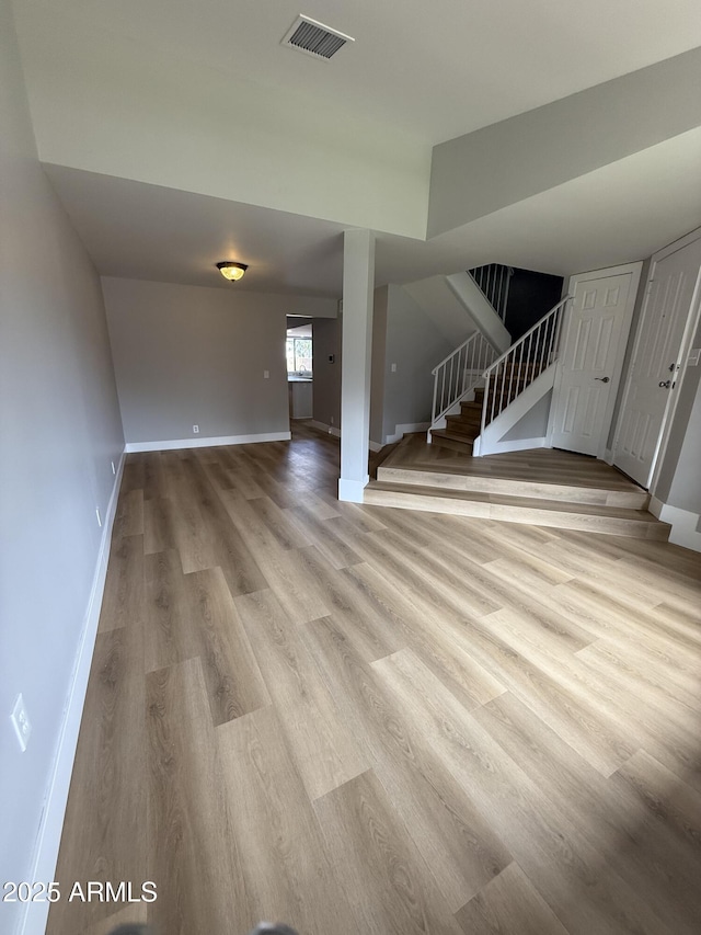 170 E Guadalupe Rd Unit 173, Gilbert, AZ 85234 - unfurnished living room with stairway, light wood-style floors, and baseboards