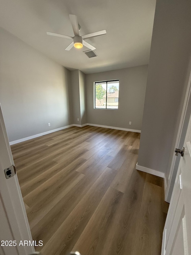 170 E Guadalupe Rd Unit 173, Gilbert, AZ 85234 - empty room with wood finished floors, baseboards, and a ceiling fan
