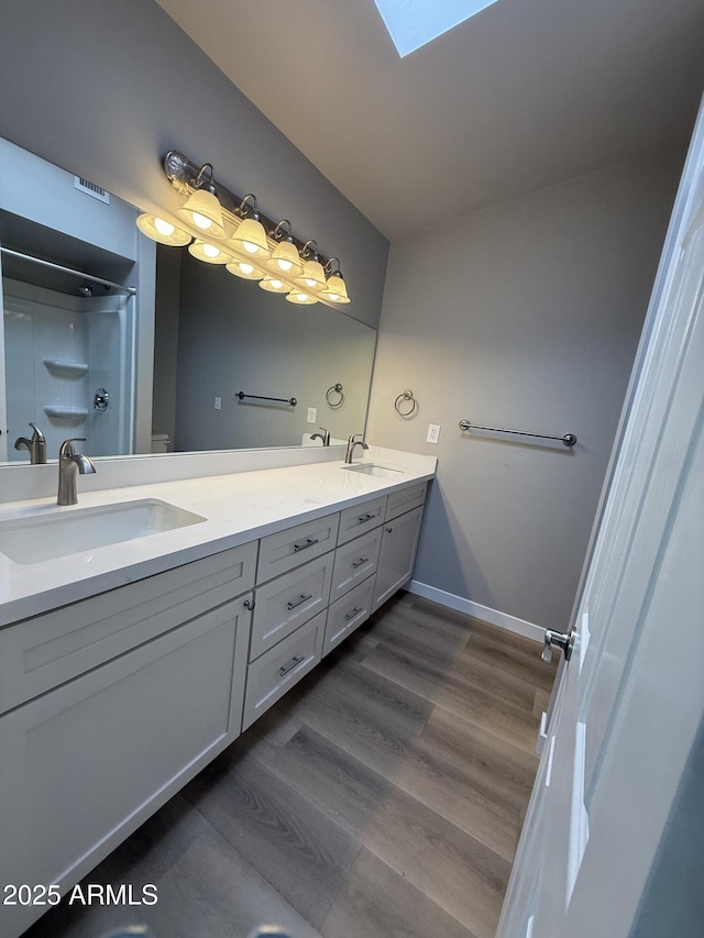 170 E Guadalupe Rd Unit 173, Gilbert, AZ 85234 - full bath featuring double vanity, wood finished floors, a shower, and a skylight
