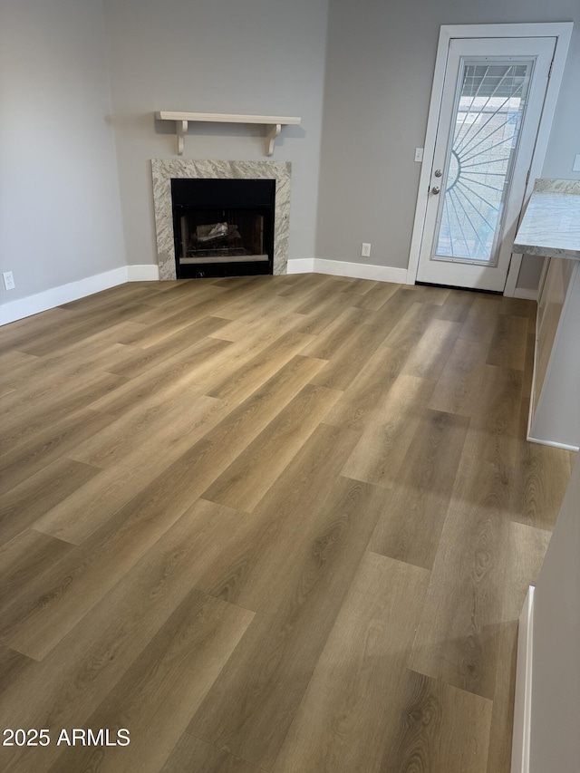 170 E Guadalupe Rd Unit 173, Gilbert, AZ 85234 - unfurnished living room with a fireplace, wood finished floors, and baseboards