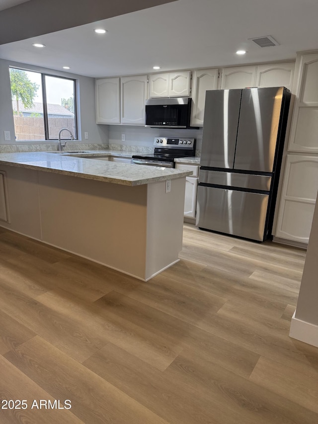 170 E Guadalupe Rd Unit 173, Gilbert, AZ 85234 - kitchen featuring stainless steel appliances, a sink, light wood-style floors, light stone countertops, and recessed lighting