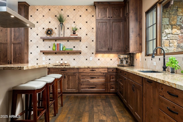 8454 E Leaning Rock Rd, Scottsdale, AZ 85266 - kitchen with light stone counters, a sink, wall chimney exhaust hood, and backsplash