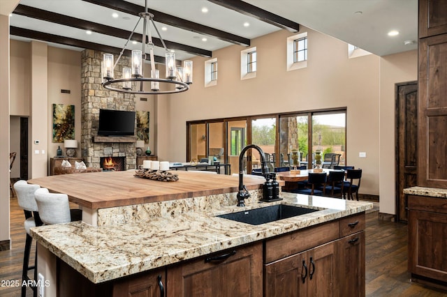 8454 E Leaning Rock Rd, Scottsdale, AZ 85266 - kitchen with a sink, open floor plan, a chandelier, dark wood-style floors, and a spacious island