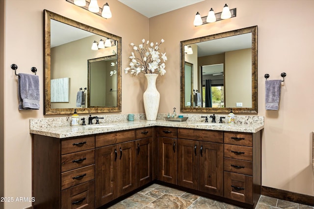 8454 E Leaning Rock Rd, Scottsdale, AZ 85266 - full bath featuring stone finish flooring, double vanity, and a sink
