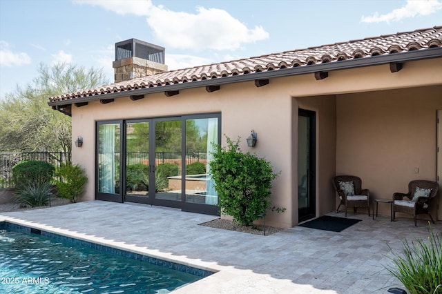 8454 E Leaning Rock Rd, Scottsdale, AZ 85266 - back of property featuring a patio area, an outdoor pool, a tiled roof, and a chimney