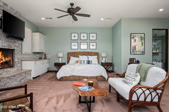 8454 E Leaning Rock Rd, Scottsdale, AZ 85266 - bedroom featuring recessed lighting, visible vents, a stone fireplace, and light colored carpet