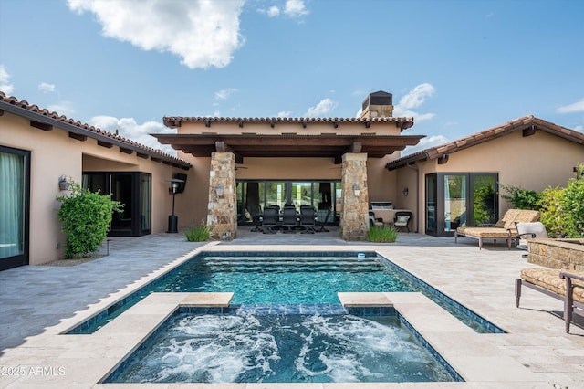 8454 E Leaning Rock Rd, Scottsdale, AZ 85266 - rear view of property with a tiled roof, a pool with connected hot tub, stucco siding, a patio, and a chimney
