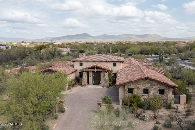 8454 E Leaning Rock Rd, Scottsdale, AZ 85266 - mediterranean / spanish-style home featuring a mountain view, stone siding, a chimney, and a tile roof