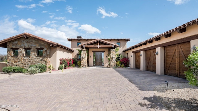 8454 E Leaning Rock Rd, Scottsdale, AZ 85266 - mediterranean / spanish-style home featuring a tiled roof, a garage, stucco siding, and decorative driveway