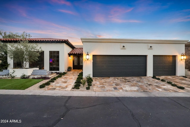 2421 E Montebello Ave, Phoenix, AZ 85016 - view of front of house with a tile roof, decorative driveway, stucco siding, and an attached garage