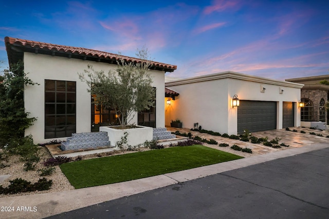 2421 E Montebello Ave, Phoenix, AZ 85016 - mediterranean / spanish home with driveway, stucco siding, a tile roof, and a garage