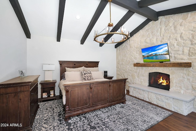 2421 E Montebello Ave, Phoenix, AZ 85016 - bedroom featuring lofted ceiling with beams, a fireplace, wood finished floors, and a chandelier