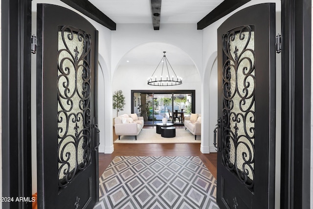 2421 E Montebello Ave, Phoenix, AZ 85016 - foyer entrance featuring arched walkways, dark wood-style floors, an inviting chandelier, and beamed ceiling