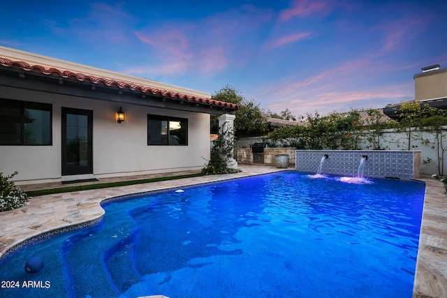 2421 E Montebello Ave, Phoenix, AZ 85016 - pool at dusk with fence, a patio, and a fenced in pool