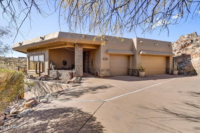 southwest-style home featuring a garage