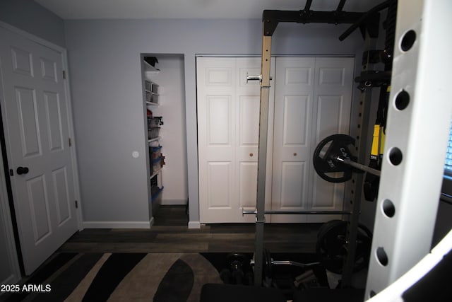 workout room featuring dark wood-type flooring