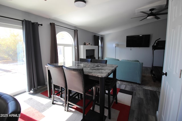 dining room with lofted ceiling, dark hardwood / wood-style floors, and ceiling fan