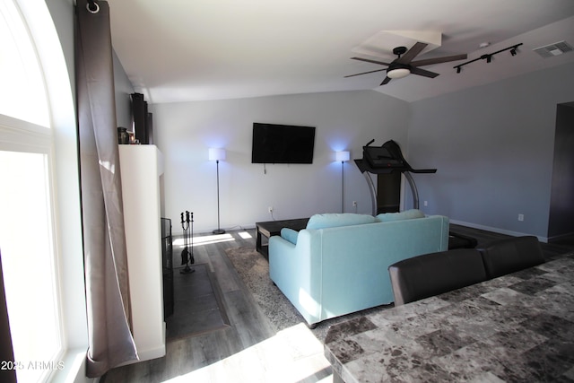 living room with lofted ceiling, dark wood-type flooring, and ceiling fan