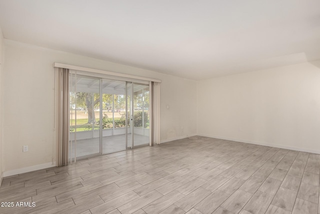 spare room with light hardwood / wood-style flooring