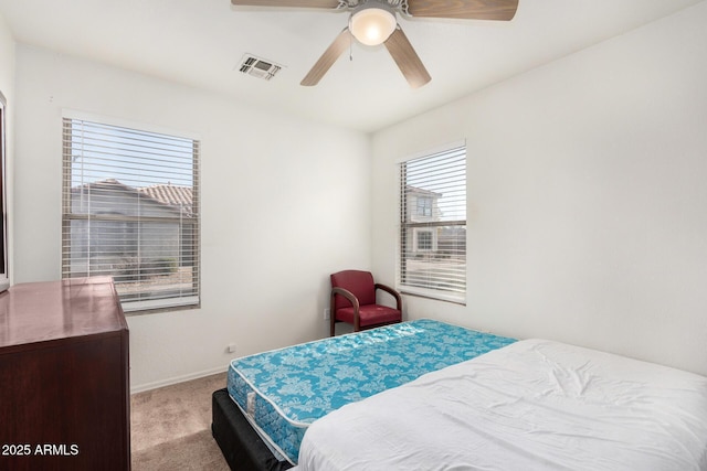 bedroom featuring light carpet and ceiling fan