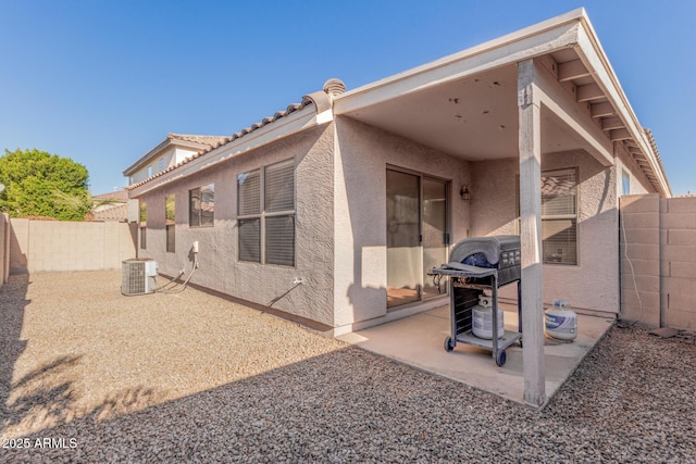 rear view of house with a patio and central air condition unit