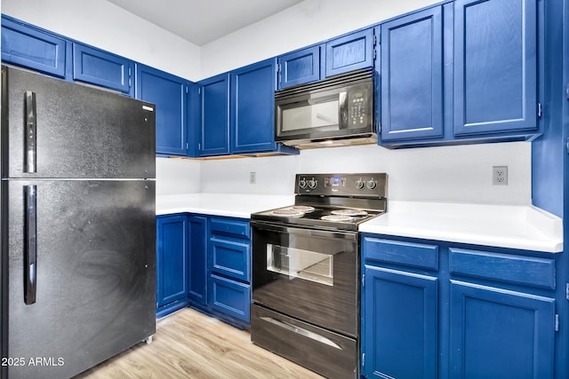 kitchen with black appliances, light hardwood / wood-style floors, and blue cabinetry