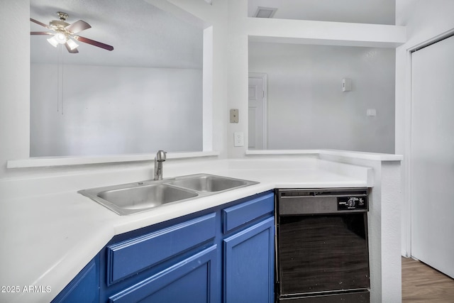 kitchen featuring ceiling fan, dishwasher, sink, dark wood-type flooring, and blue cabinets