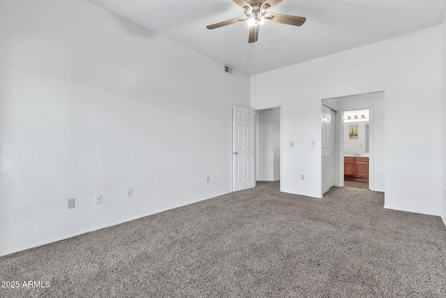 unfurnished bedroom featuring carpet, ensuite bathroom, and ceiling fan