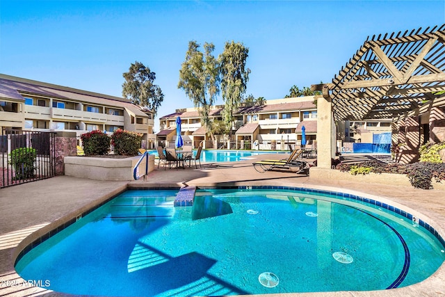 view of swimming pool featuring a pergola and a patio