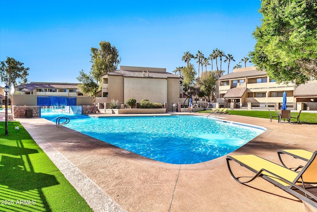 view of swimming pool featuring pool water feature and a patio