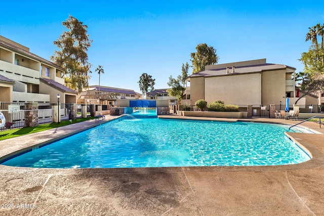 view of swimming pool with a patio area and pool water feature