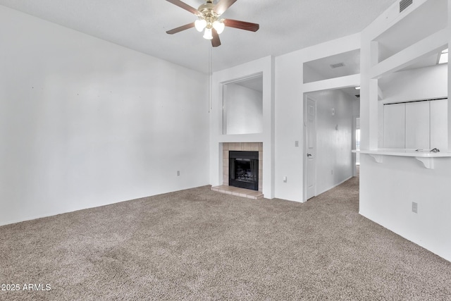 unfurnished living room with carpet flooring, ceiling fan, and a fireplace