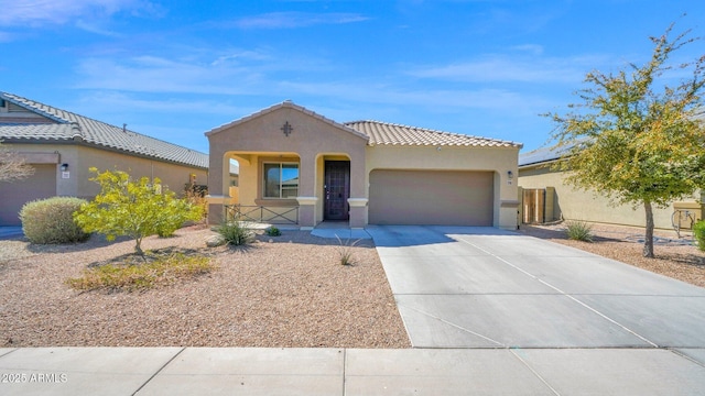 mediterranean / spanish house with an attached garage, covered porch, a tiled roof, concrete driveway, and stucco siding