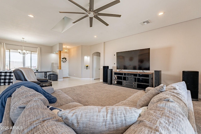 living room with arched walkways, ceiling fan with notable chandelier, visible vents, and recessed lighting