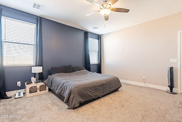 bedroom with ceiling fan, carpet flooring, visible vents, and baseboards