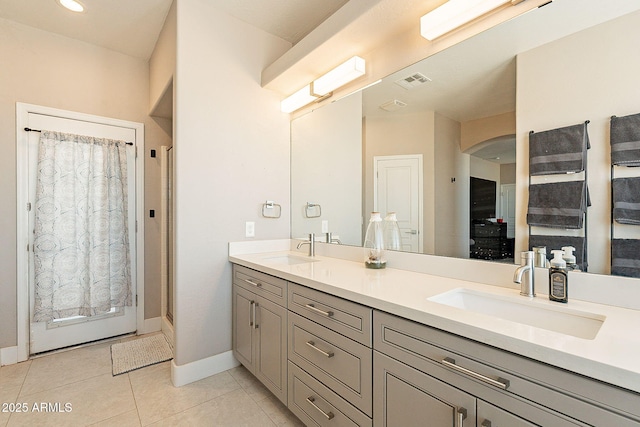 full bath featuring double vanity, tile patterned flooring, a sink, and visible vents