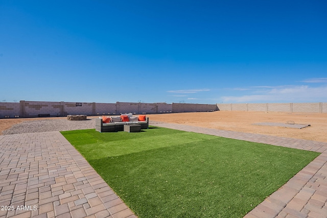 view of yard with a patio, a fenced backyard, and an outdoor living space