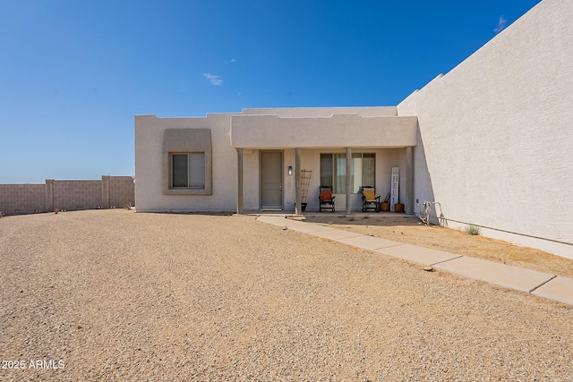 exterior space featuring fence, a patio, and stucco siding