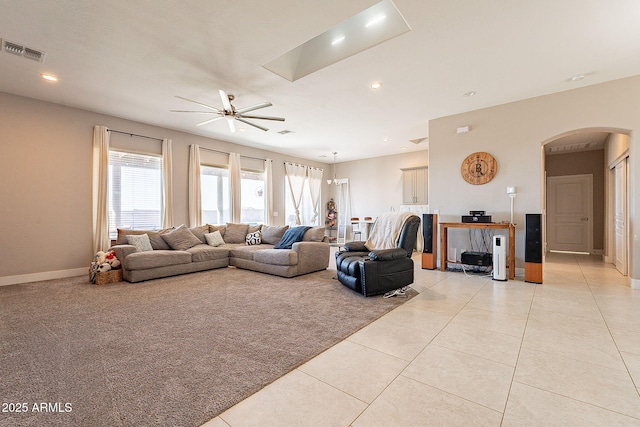 living room with visible vents, arched walkways, ceiling fan, light tile patterned flooring, and recessed lighting