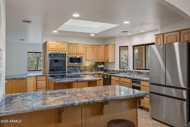 kitchen featuring black appliances, visible vents, a wealth of natural light, and a sink