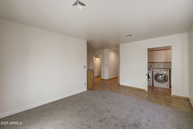 interior space with baseboards, carpet, visible vents, and washer and dryer