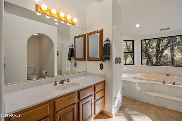 full bath with lofted ceiling, a garden tub, toilet, vanity, and visible vents