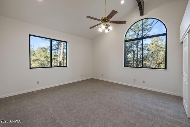 empty room with a ceiling fan, high vaulted ceiling, and baseboards