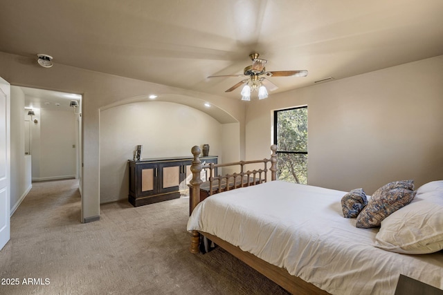 bedroom featuring a ceiling fan, light colored carpet, visible vents, and baseboards